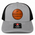A gray and black trucker cap featuring a circular leather front patch with 'The REMNANT CHURCH' text and a black visor patch reading '112 The Original MD-LG'.