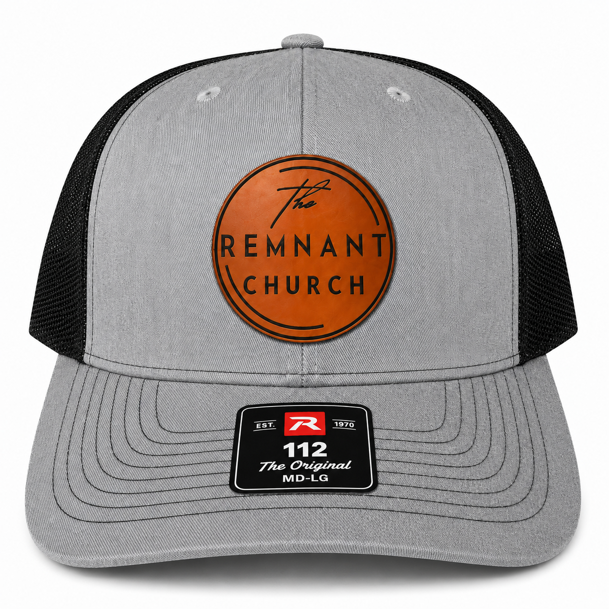 A gray and black trucker cap featuring a circular leather front patch with 'The REMNANT CHURCH' text and a black visor patch reading '112 The Original MD-LG'.